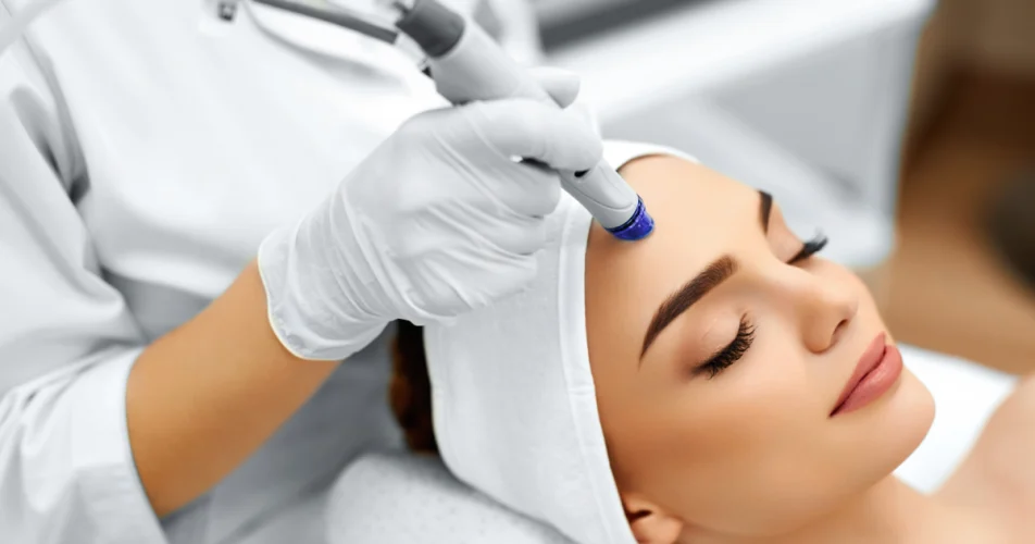 Woman receiving a Hydration Facial treatment at a spa in Geneva, IL